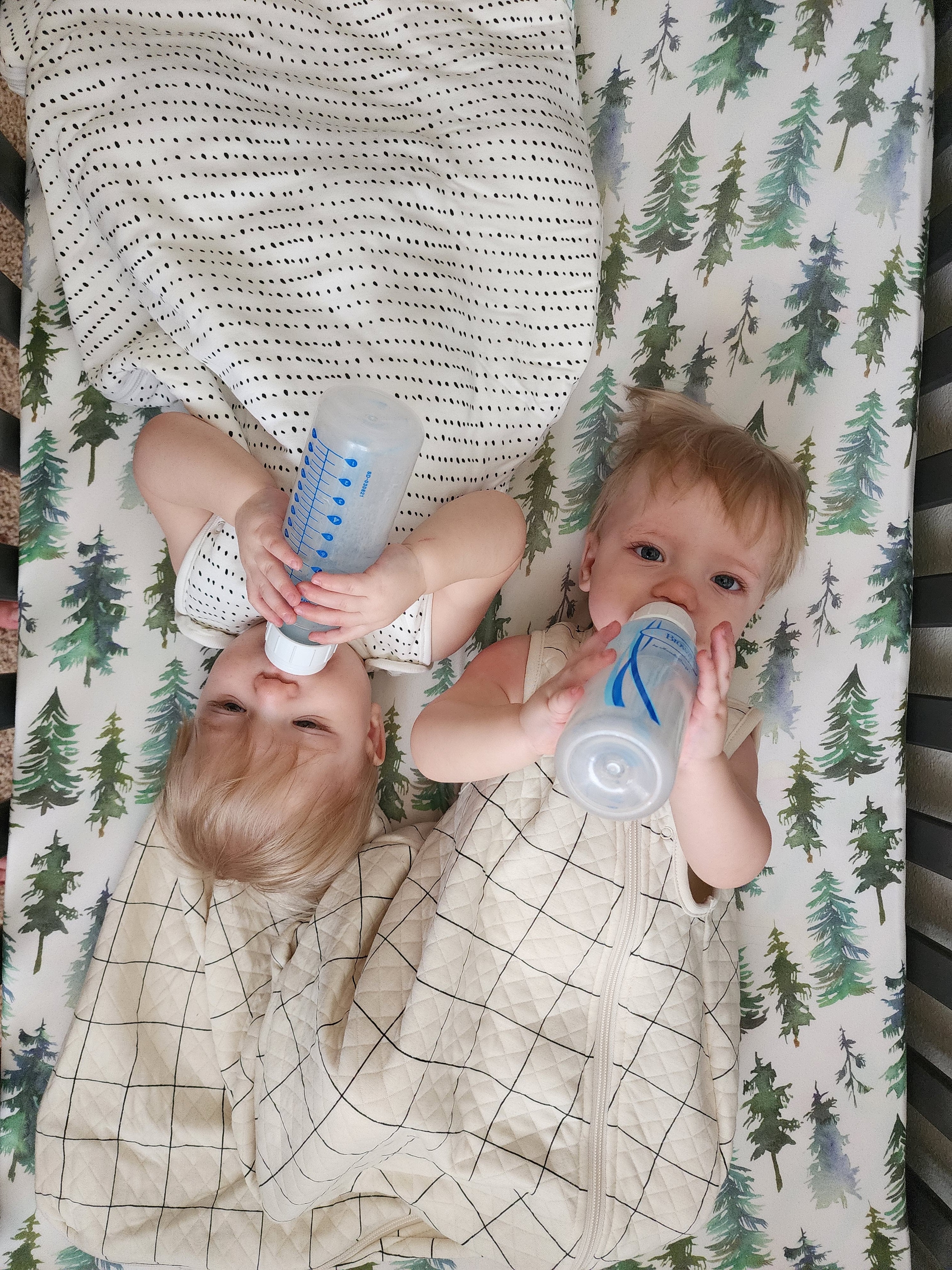 Twins drinking milk while wearing Tealbee Dreambag in different designs