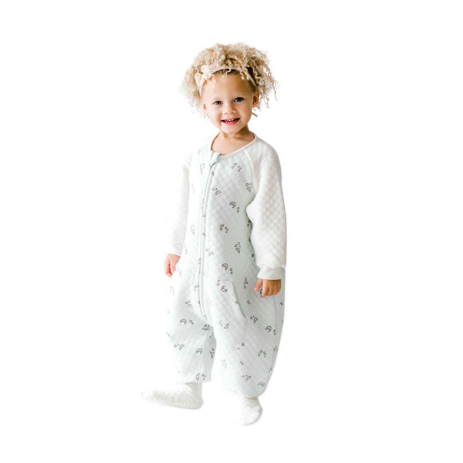 A baby standing up comfortably in a Tealbee Dreamsie, highlighting the perfect combination of warmth, coziness, and freedom of movement for a happy, restful sleep.