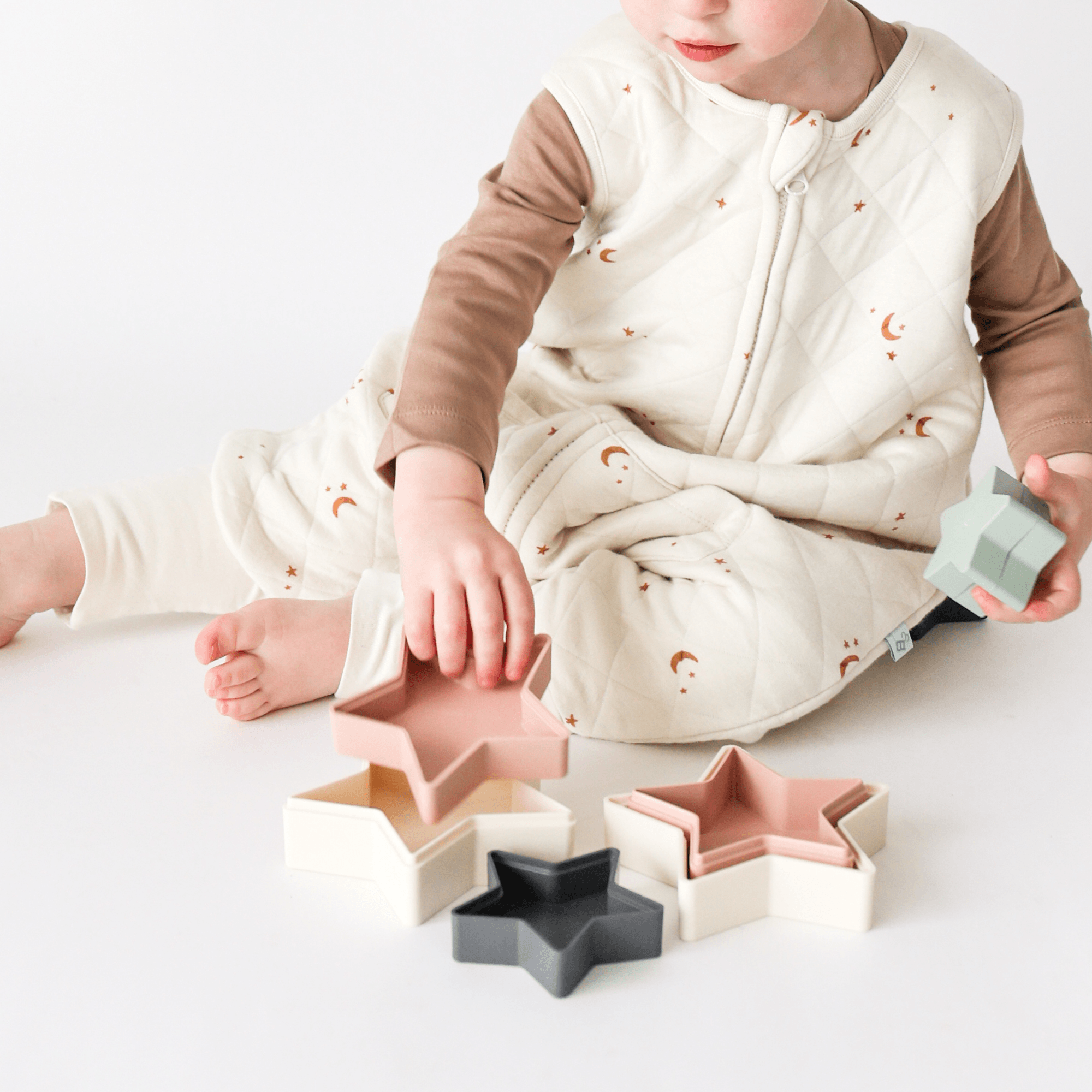 Close up of toddler playing wearing Tealbee Dreamsuit Sleepsack 1.2 TOG